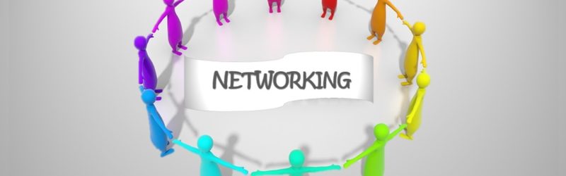 image of humans standing in a circle holding hands... networking