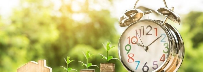 Financial Planning, Image of a clock and plants growing over coins