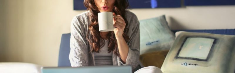 Career Break - image of a woman sipping coffee and working on her laptop
