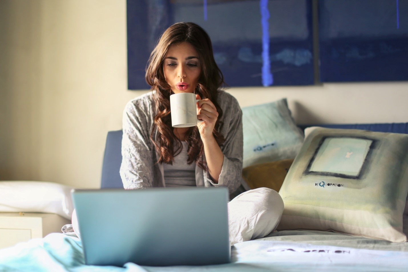 Career Break - image of a woman sipping coffee and working on her laptop