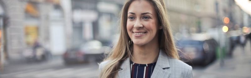 Homemaker turned career woman - image of a woman in blazer walking with a smile