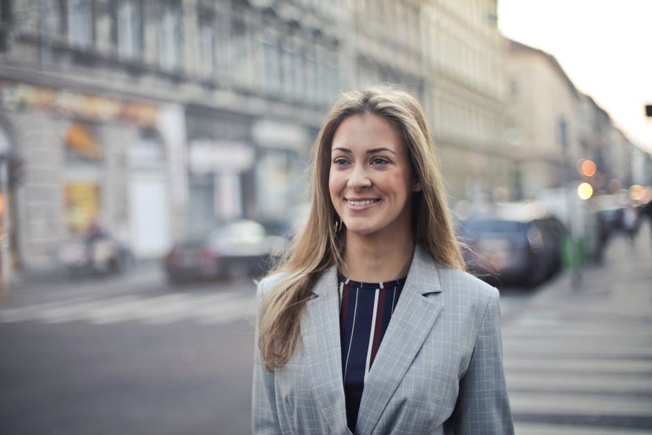 Homemaker turned career woman - image of a woman in blazer walking with a smile
